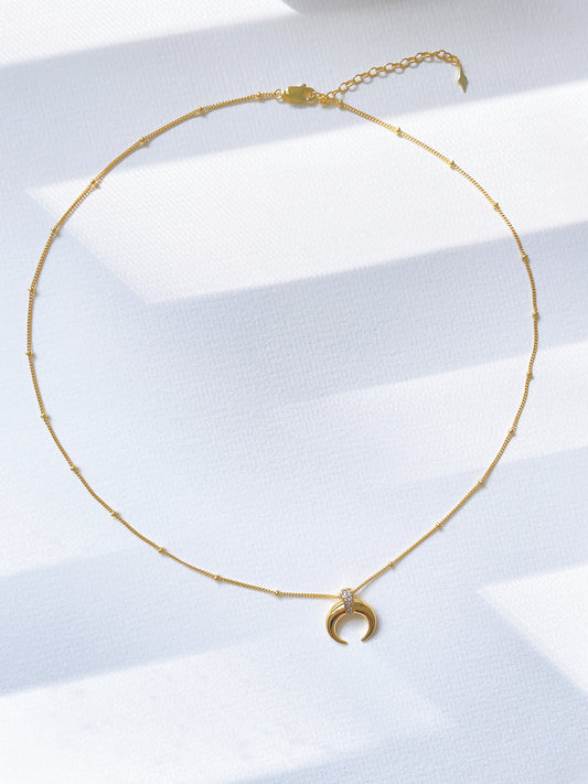 Crescent-shaped pendant necklace